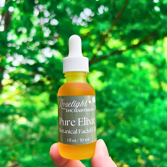 Bottle of 'Pure Elixir' botanical facial oil held in front of a green leafy background